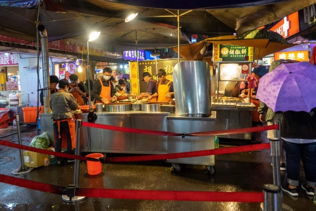 A long line outside the pepper buns stand in a Taiwan night market is a great sign this place will have great food.