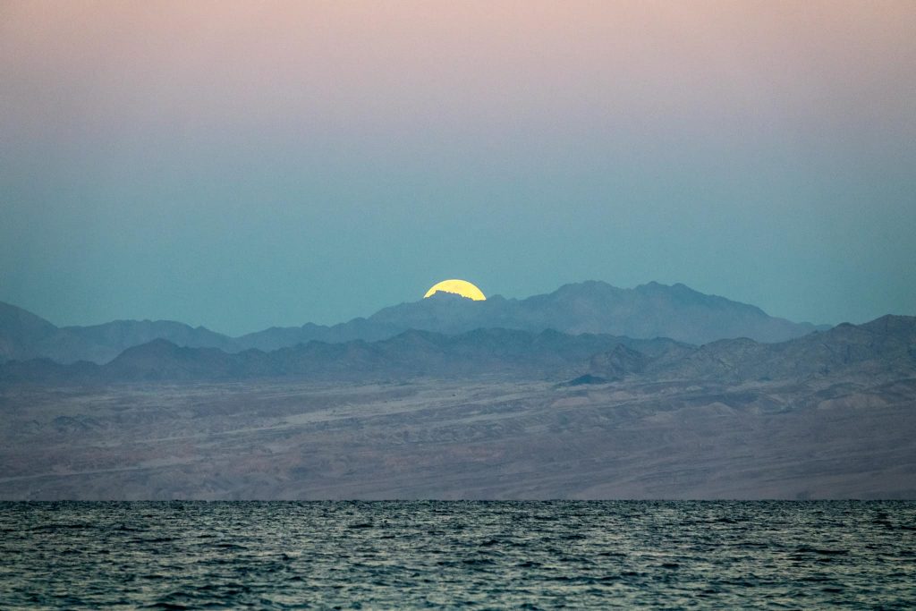 The super moon setting over Saudi Arabia, seen from from Nuweiba, Sinai.