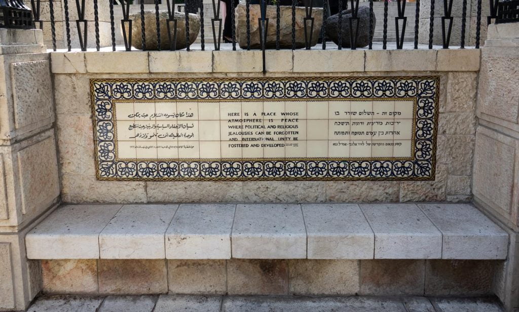 The plaque in front of the YMCA Three Arches  hotel in Jerusalem. The hotel was built as a place where people of all backgrounds could mix freely.