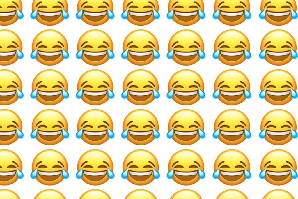 Wall of smiley faces with laugh cry emojis, to show how people laugh online in Arabic, Chinese, Spanish, Korean, Farsi, Hebrew and other languages