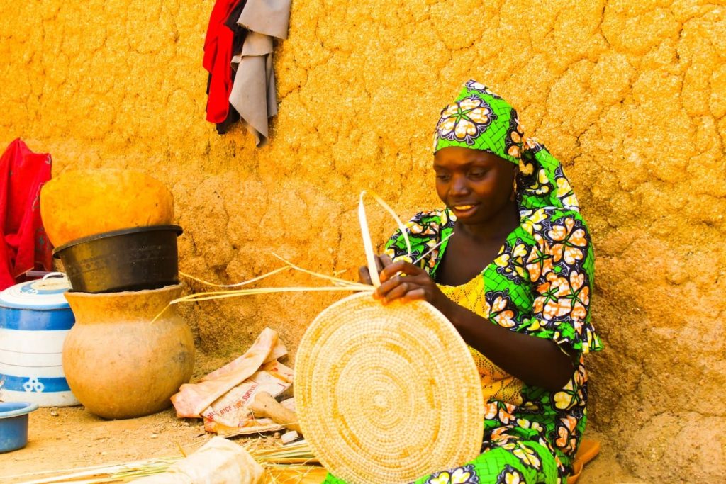 Woman weaving a basket in Kano, Nigeria, one of the homes of the African language Hausa. 