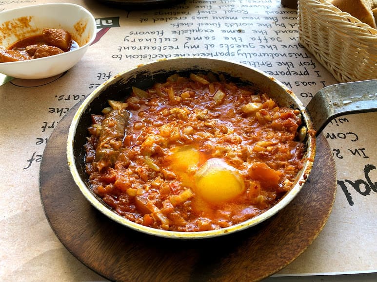 Shakshuka - oven baked eggs in meat with spices and tomato