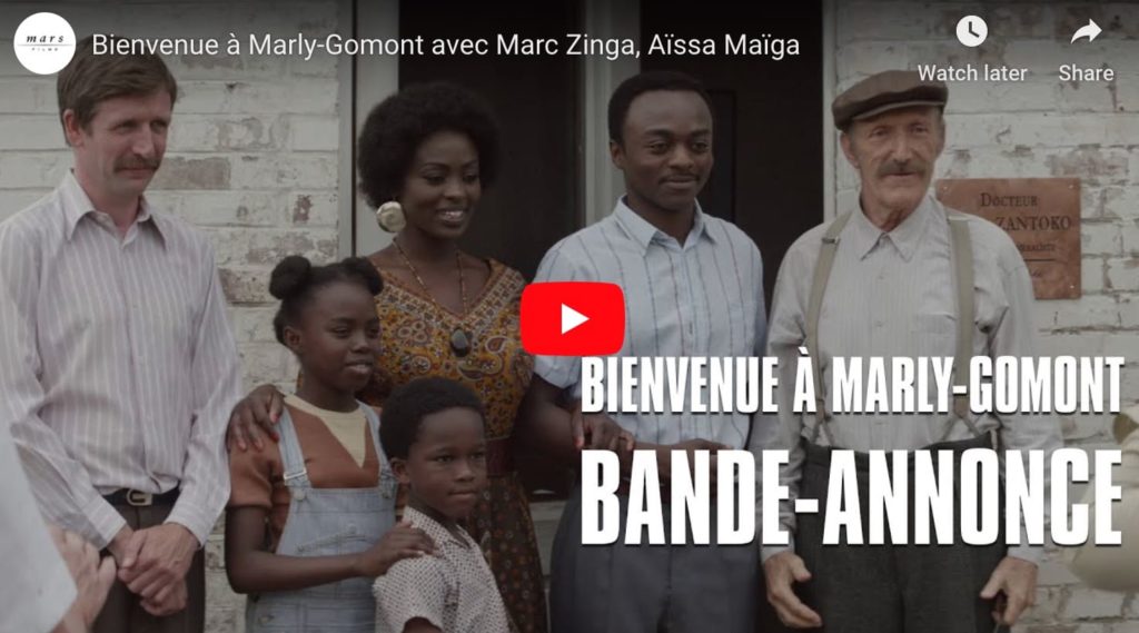 Screen capture from french film Bienvenue a Marly Gomont, a film about racism, showing a black family amidst white people