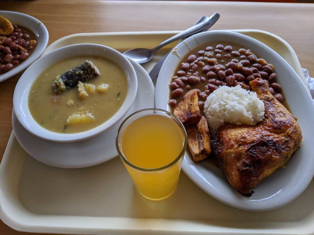 Menu del dia in Colombia. Chicken, rice, banana, beans, soup.