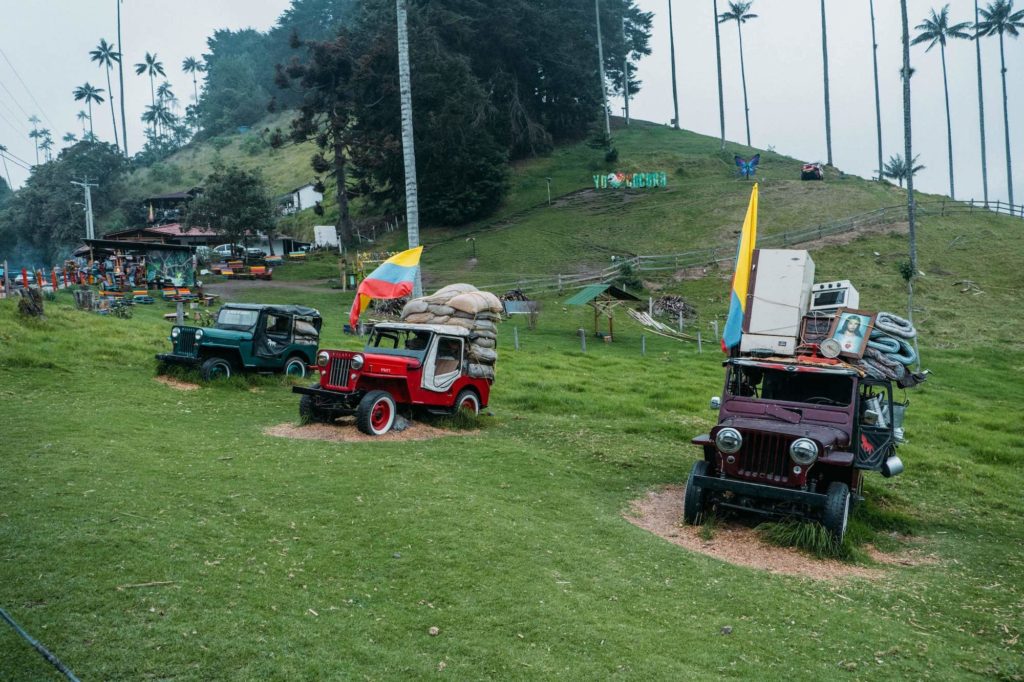 Jeeps / Willys on grass in Valle de Cocora with Colombian flag