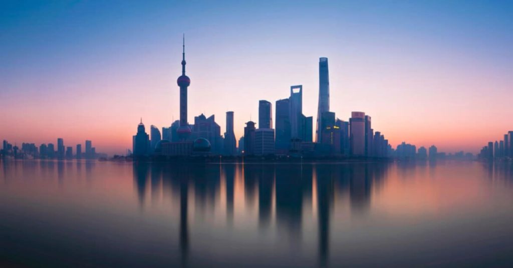 Shanghai at dawn with pink and blue skyline, where you'd be expected to say good morning in chinese 