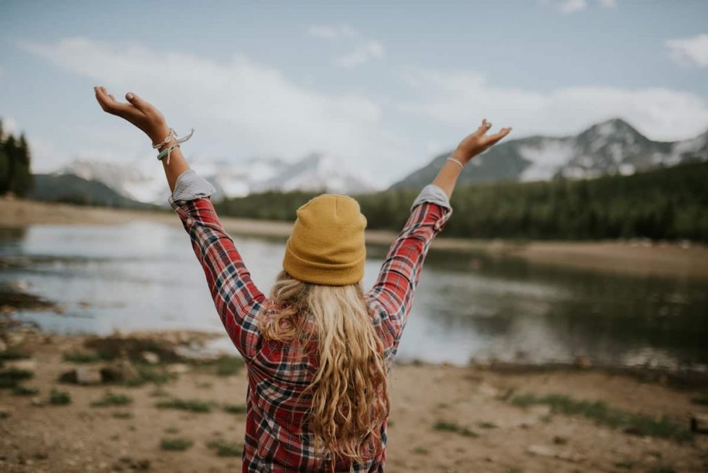 Yes in German - Woman in Nature Hands Raised